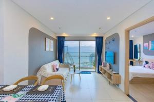a room with a bedroom with a bed and a desk at The Sóng Infinity Pool Apartment Vung Tau Near Beach in Vung Tau +147 photos