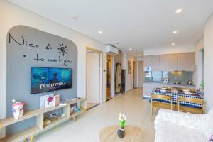 a living room with a kitchen and a dining room at The Sóng Infinity Pool Apartment Vung Tau Near Beach in Vung Tau