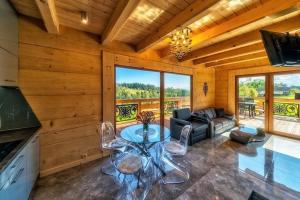 a living room with a table and a couch at Luxury holiday villa, pool, sauna, jacuzzi in Nowy Targ