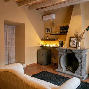 a living room with a fireplace and a kitchen at Habibi Hotel and SPA in San Miguel de Allende