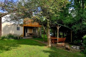 a house with a deck and a bench in a yard at Lakeside holiday villa, private garden in Wierzchowo