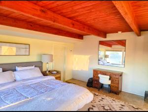 a bedroom with a bed and a desk and a mirror at Ocean view-Huge backyard-Quiet neighborhood in Bodega Bay