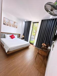 a bedroom with a bed and a large window at Villa Flamingo B109 in Thanh Hóa
