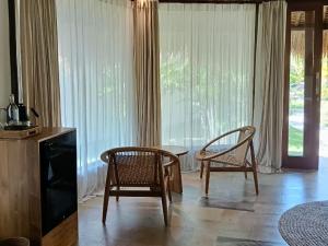 a living room with two chairs and a table at Emocean Beach Boutique Dive Resort in Amed