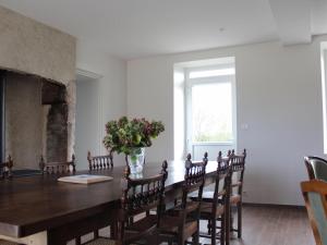 a dining room with a table and chairs and a fireplace at Gîte de charme à la campagne - 6 pers. - FR-1-489-17 in Bagneux
