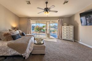 a bedroom with a bed and a ceiling fan at Lake House in Fort Mohave