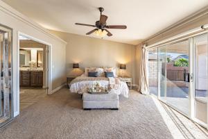a bedroom with a bed and a ceiling fan at Lake House in Fort Mohave