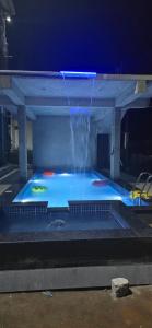 a large swimming pool with a water fountain at Sunrise Inn in Yelagiri
