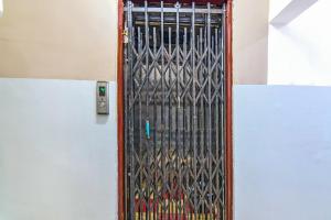 a door with a metal gate in a building at OYO 82026 BANGUR INN in Nager Bazaar