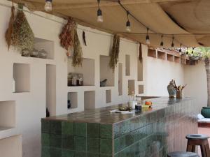 a bar with a green tile counter in a room at Taura Wellness House - Boutique Stay & Experiences in Antigua Guatemala in Antigua Guatemala