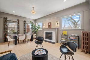 a living room with a table and chairs and a fireplace at Elegant and Chic 2Bed 2Bath steps from the lake! in Chicago