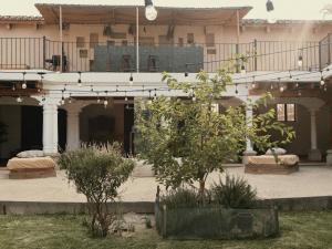 a building with a courtyard with a tree in front of it at Taura Wellness House - Boutique Stay & Experiences in Antigua Guatemala in Antigua Guatemala