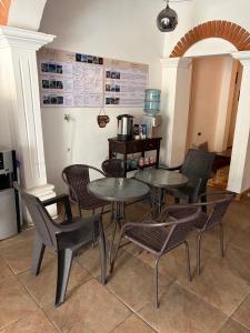 a restaurant with tables and chairs in a room at Zoola Suites Antigua in Antigua Guatemala