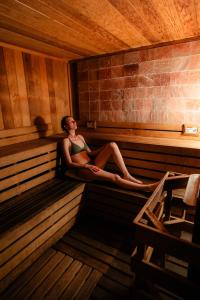 a woman is sitting in a sauna at Chaminade Resort & Spa in Santa Cruz +87 photos