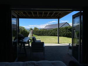 a view of a patio with a table and chairs at D'Archiac Studio in Lake Tekapo