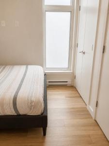 a bedroom with a bed and a window at Lovely Brand New Suite in Sidney