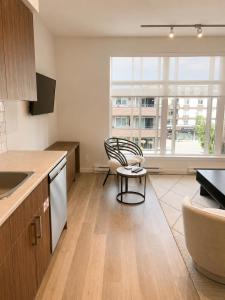 an empty kitchen with a chair and a window at Lovely Brand New Suite in Sidney
