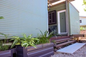 a front porch of a house with plants on it at Weipa Motel Resort in Weipa