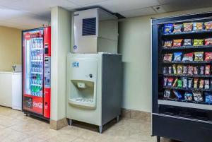a soda machine in a store next to a refrigerator at Wingate by Wyndham Conway AR in Conway +11 photos