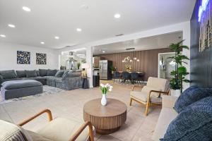 a living room with a couch and a table at Heated Pool - Jacuzzi - Firepit - Game Room in Hemet