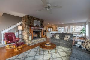 a living room with a couch and a fireplace at Blue Ridge Vista in Seven Devils