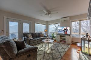 a living room with couches and a flat screen tv at Blue Ridge Vista in Seven Devils