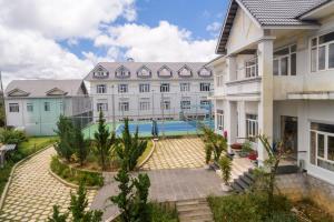 an exterior view of a building with a swimming pool at Navy Hotel Da Lat in Da Thien