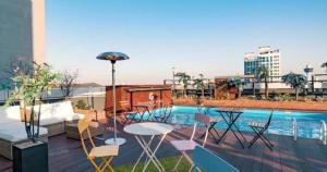 a patio with chairs and a table and a pool at Gold Coast Hotel Incheon in Incheon
