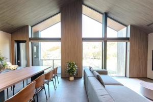 a dining room with a long table and chairs at Forest Resort Oak in Hakuba