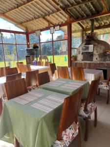 a dining room with a table and chairs and an oven at RESORT ALAPA in Huancayo