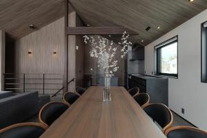 a conference room with a wooden table and chairs at Forest Resort Oak in Hakuba