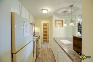 a kitchen with a refrigerator and a counter top at Aspen East Unit #101 in Basye