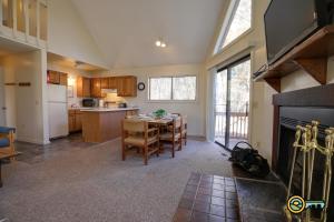 a kitchen and dining room with a table and a fireplace at Villa #91 in Basye