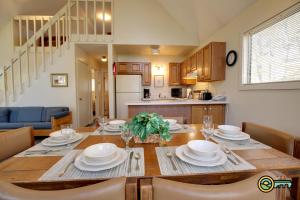a kitchen and dining room with a wooden table with plates and dishes at Villa #91 in Basye