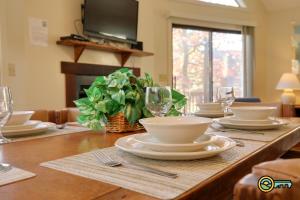 a wooden table with plates and dishes on it at Villa #91 in Basye