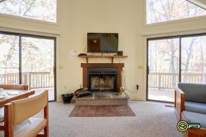 a living room with a fireplace and a tv at Villa #91 in Basye +34 photos