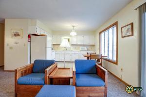 a living room with two chairs and a table and a kitchen at Villa #114 in Basye