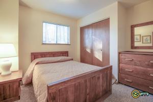 a bedroom with a bed and a dresser and a mirror at Villa #119 in Basye +15 photos