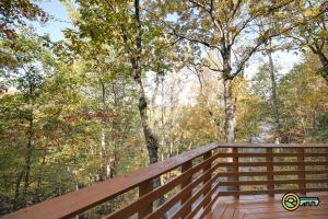 a wooden deck with trees in the background at Villa #102 in Basye