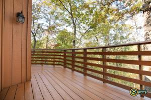 a porch of a house with a wooden deck at Villa #102 in Basye