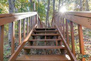 a staircase leading up to a deck in the woods at Villa #102 in Basye