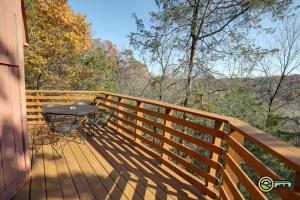 a wooden deck with a table and a view of the woods at Villa #364 in Basye
