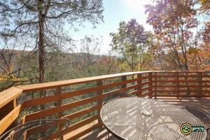 a table and chairs on a wooden deck with a view at Villa #364 in Basye