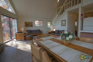a dining room with a table and a living room at Villa #364 in Basye +22 photos
