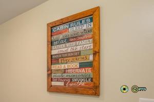 a framed sign on a wall in a room at Aspen East Unit #231: Slippery Slope in Basye