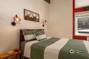 a bedroom with a bed and two lamps and a window at Aspen East Unit #231: Slippery Slope in Basye