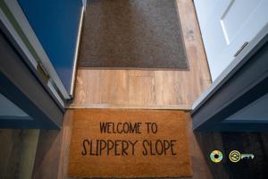 a welcome to slippery slope sign on the door of a house at Aspen East Unit #231: Slippery Slope in Basye