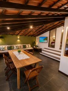 a dining room with a wooden table and chairs at Pousada Mojomar Buzios in Búzios