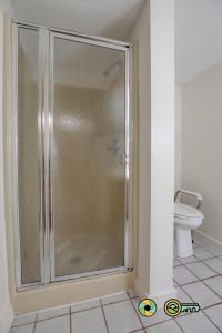 a glass shower in a bathroom with a toilet at Senedo Springs Duplex #101A in Basye