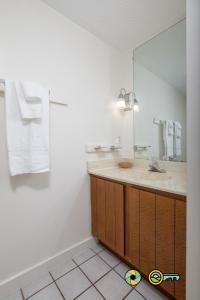 a bathroom with a sink and a mirror at Senedo Springs Duplex #101A in Basye +21 photos